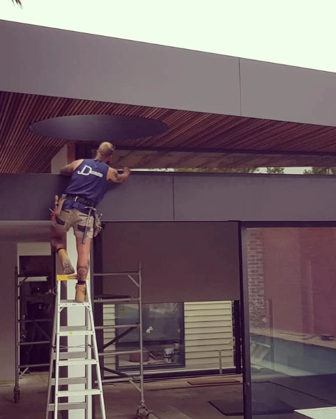 JD carpenter installing the timber soffit around its circular opening at Clifton Hill